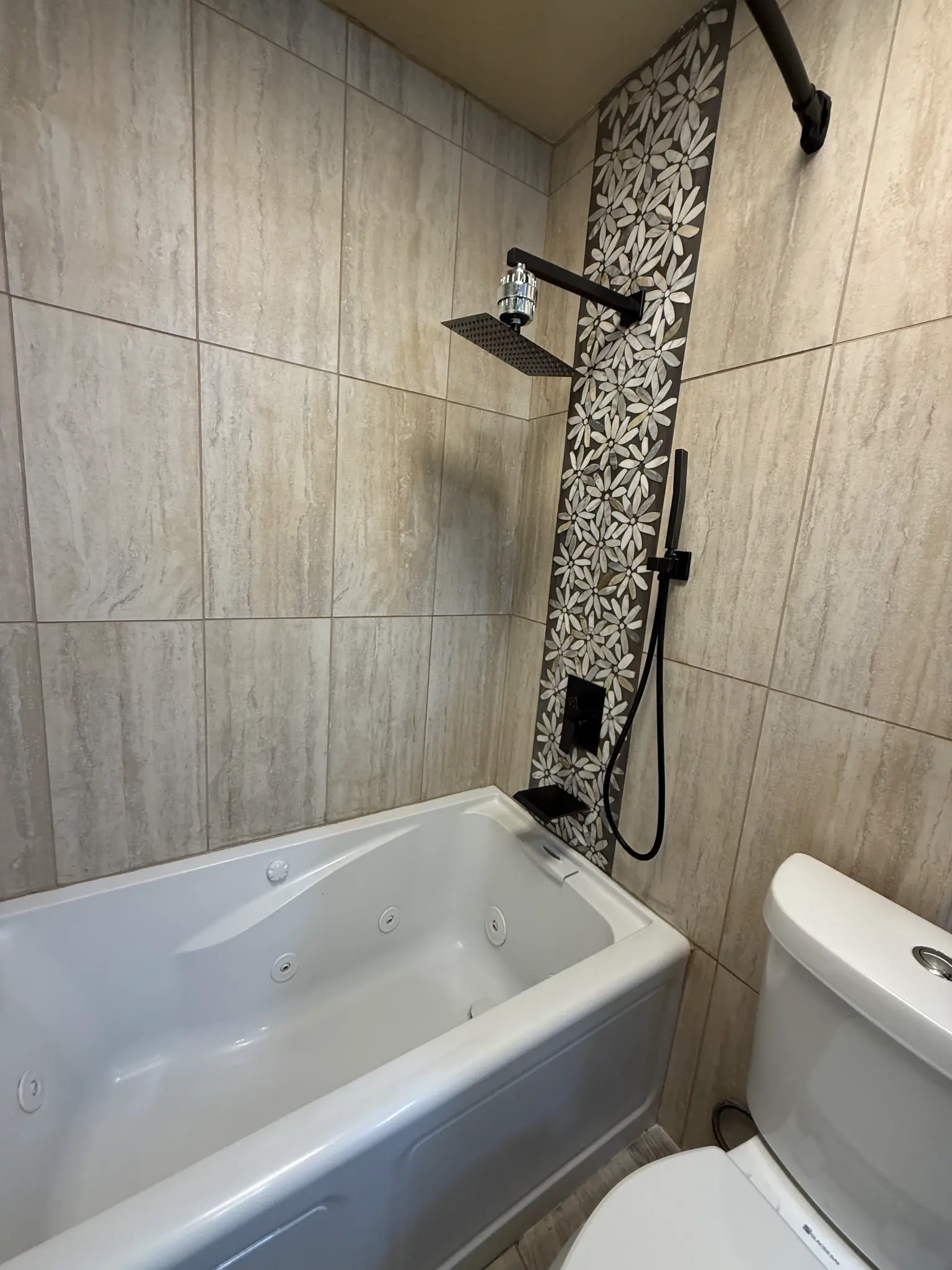 Shower with decorative tile strip